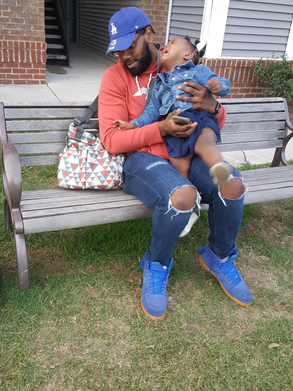 Dad with mommy bag and baby crying. Dads deserve better diaper bags for dads